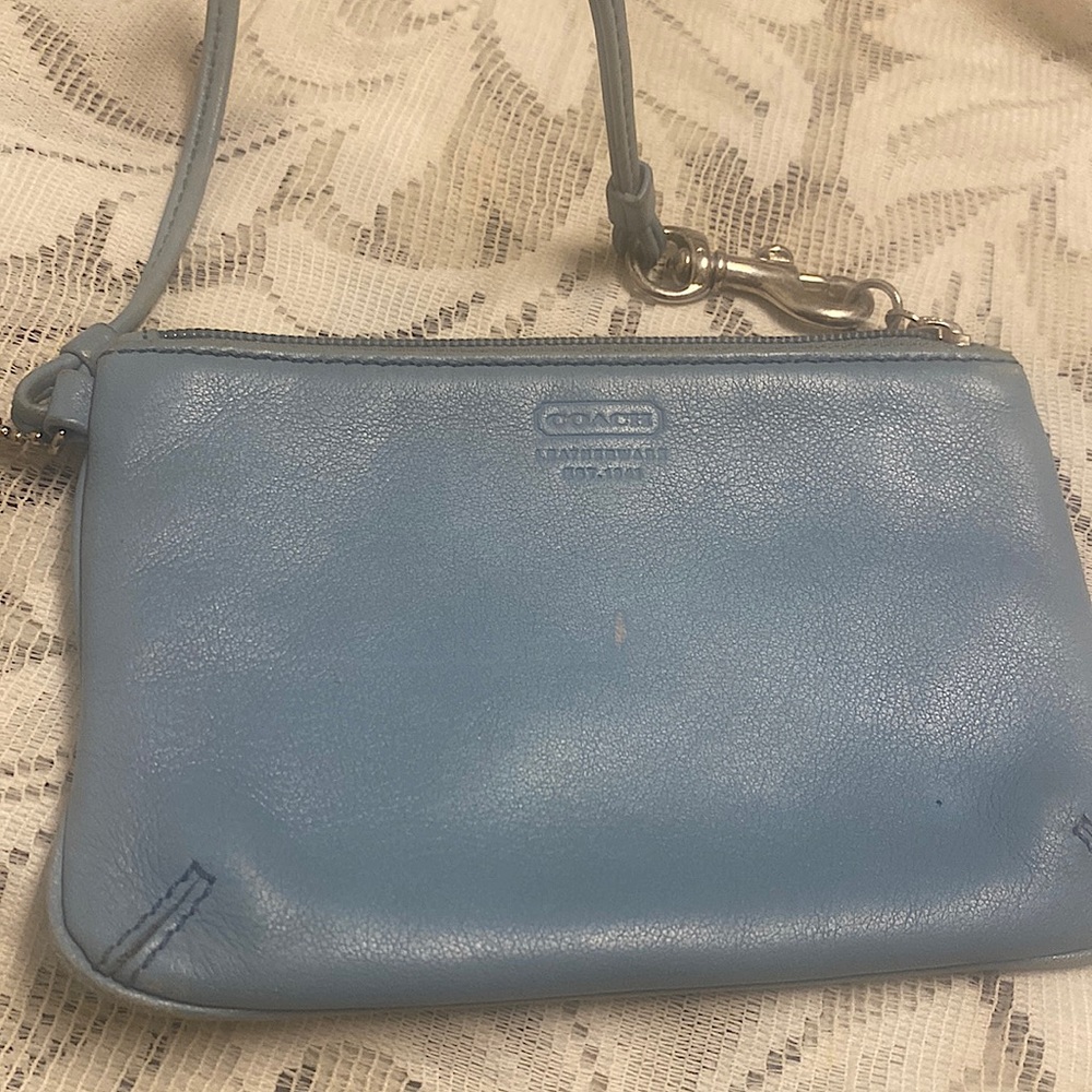 Small light blue Coach wristlet have some wear.